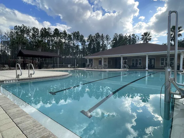 a view of a swimming pool with a table under an umbrella
