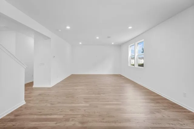 a view of kitchen with windows and refrigerator