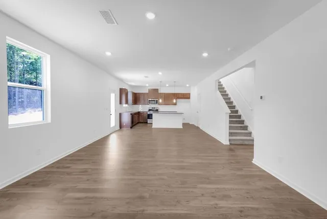 a view of kitchen with microwave and cabinets