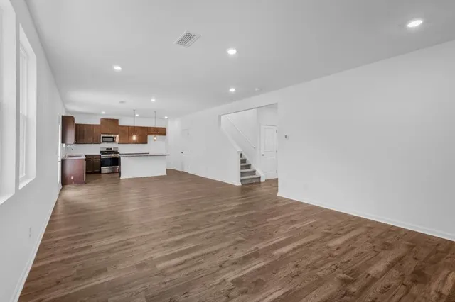 a kitchen with stainless steel appliances granite countertop a sink a microwave oven and a counter space