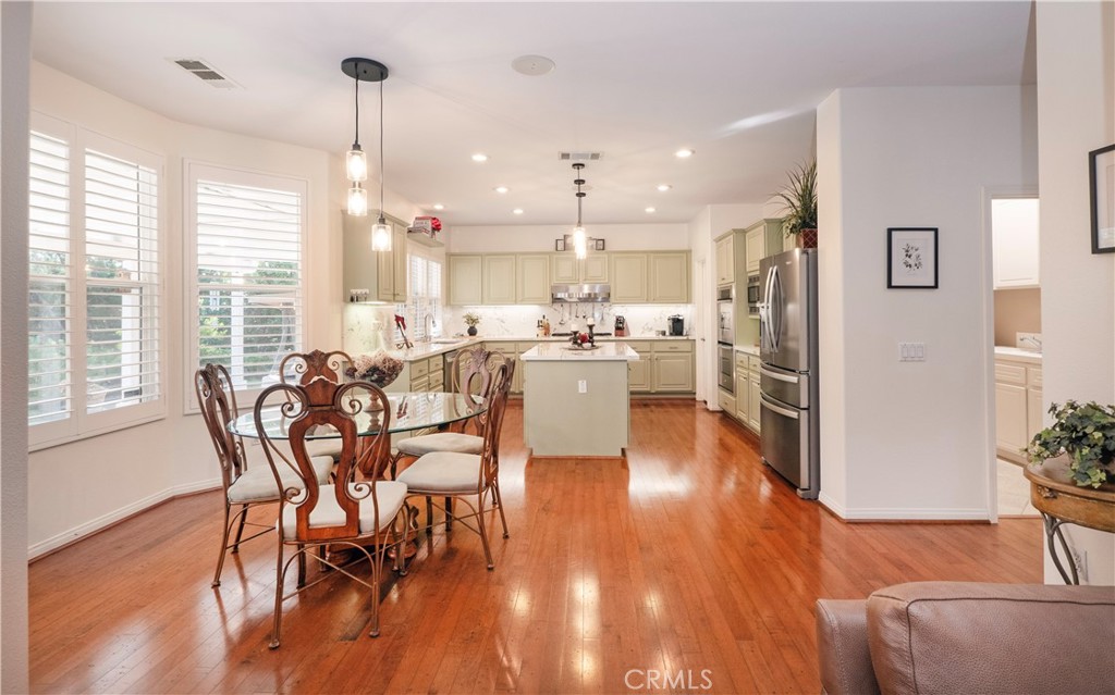 14251 Ashton Lane Riverside, CA 92508 - Photo 15 of 69 a view of a dining room and livingroom with furniture wooden floor a chandelier