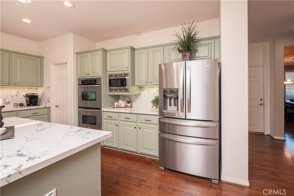 14251 Ashton Lane Riverside, CA 92508 - Photo 23 of 69 a kitchen with stainless steel appliances kitchen island granite countertop a refrigerator and a stove top oven