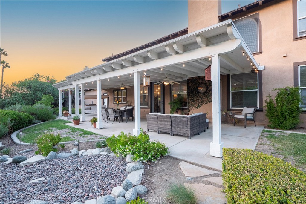 14251 Ashton Lane Riverside, CA 92508 - Photo 60 of 69 a view of a patio with table and chairs potted plants and floor to ceiling window