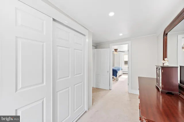 a living room with furniture a wooden floor and next to a window