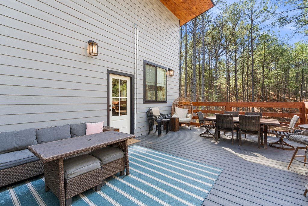 126 Hummingbird Way Copperhill, TN 37317 - Photo 42 of 47 a backyard of a house with wooden floor outdoor seating and yard in the back