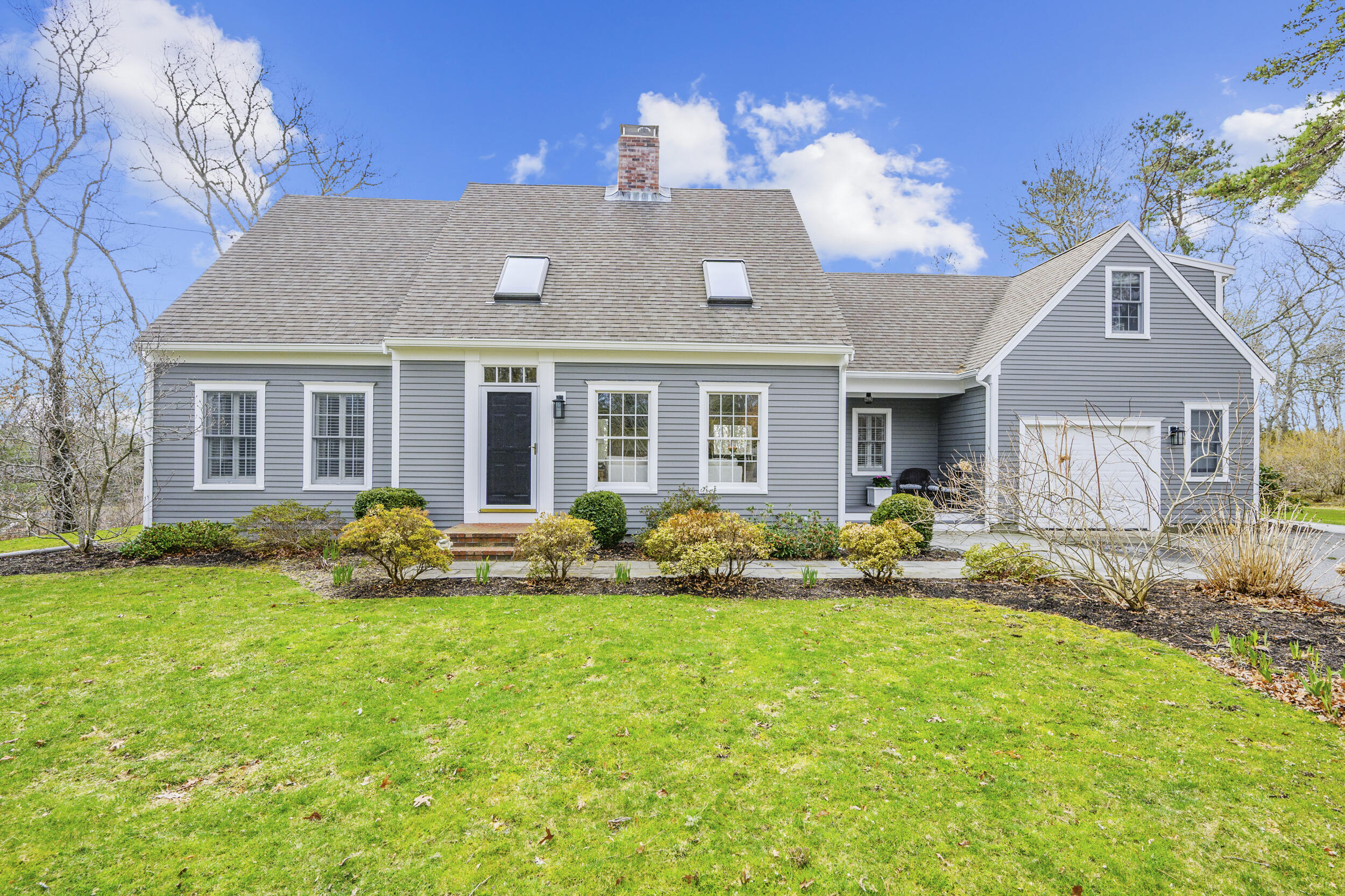 a front view of house with yard and outdoor seating