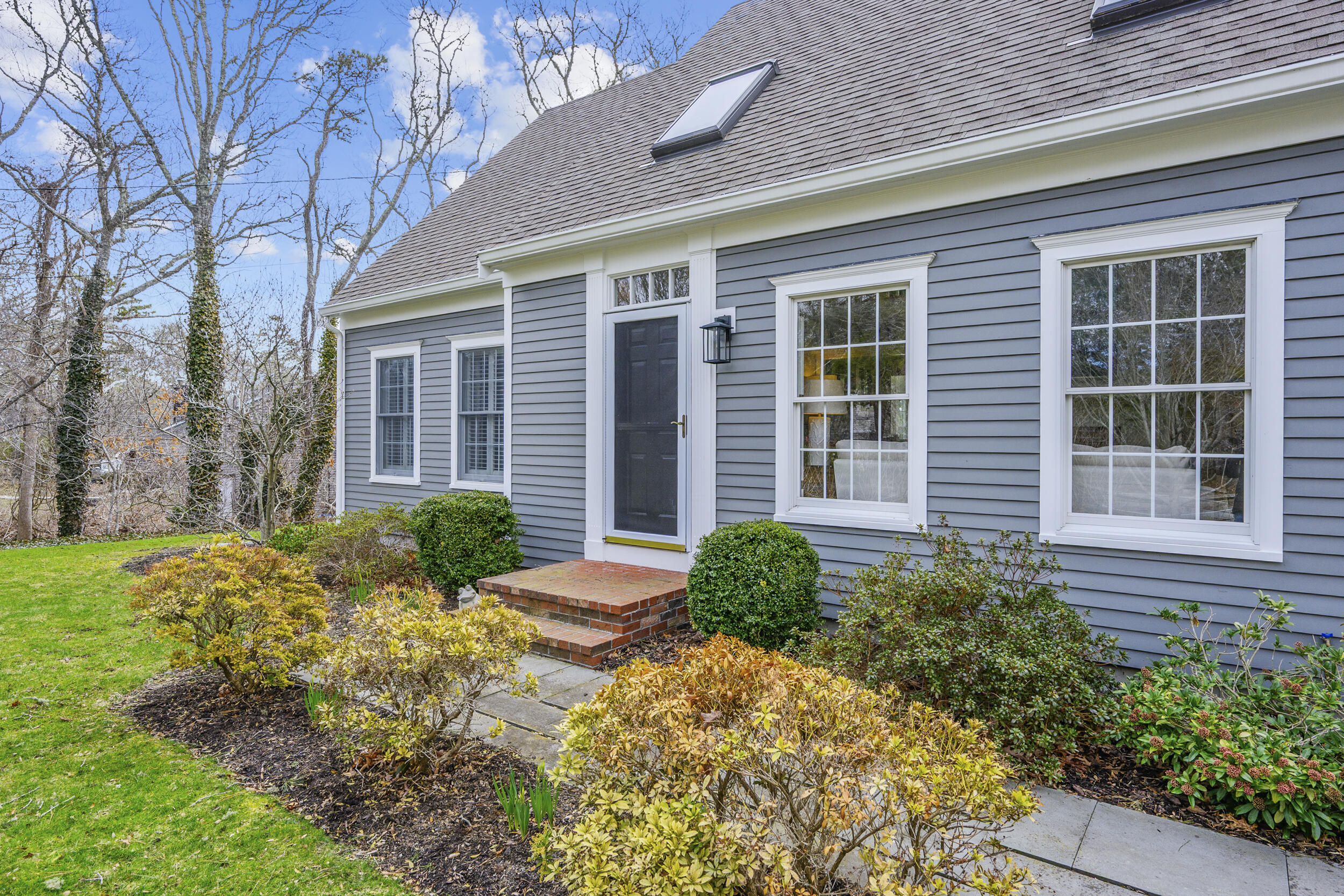83 Cemetery Road Harwich, MA 02645 - Photo 3 of 53 a front view of a house with garden and plants