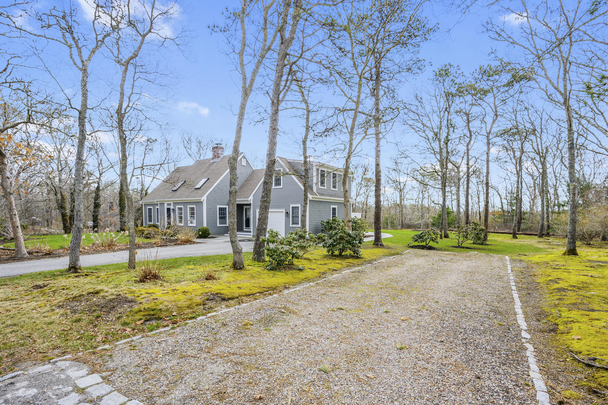 83 Cemetery Road Harwich, MA 02645 - Photo 51 of 53 a view of a swimming pool with lawn chairs and large trees