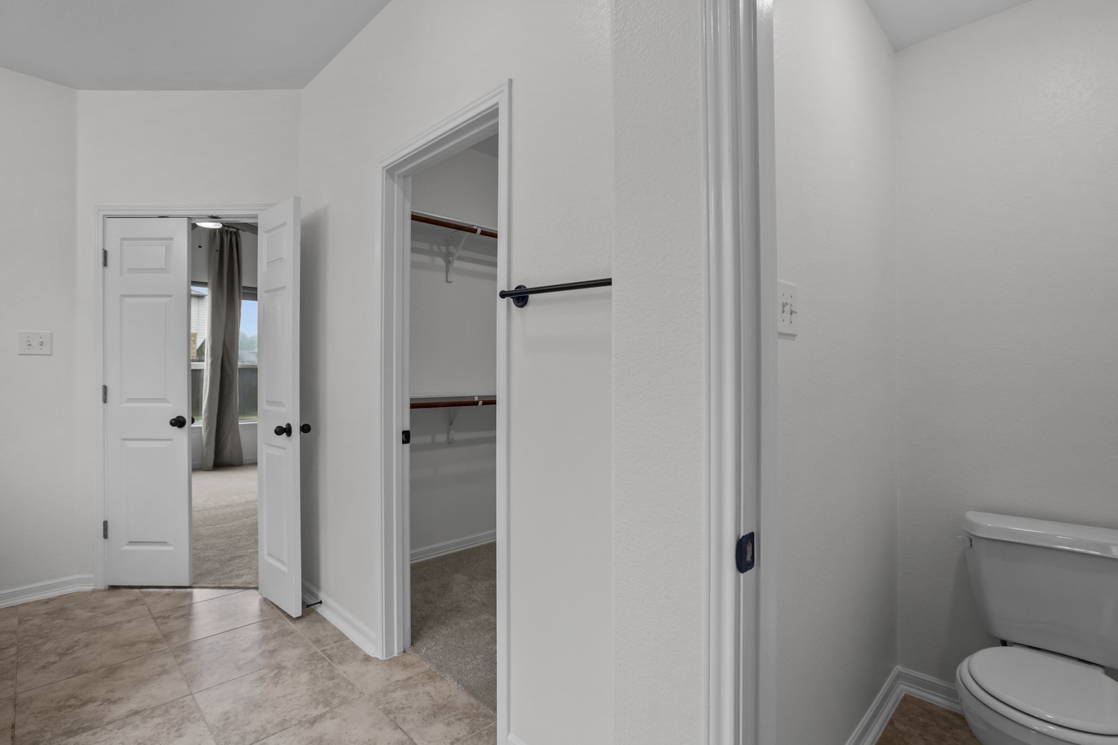 245 Razzmatazz Trail Buda, TX 78610 - Photo 22 of 37 Bathroom area featuring tiled flooring, a traditional toilet, and a private water closet