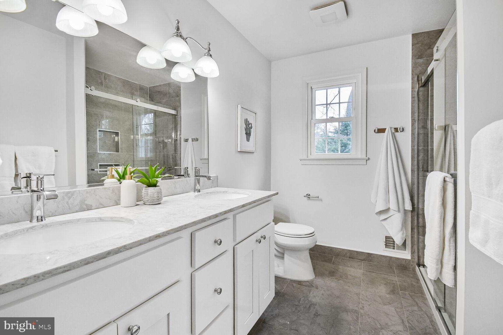 309 Notley Court Silver Spring, MD 20905 - Photo 20 of 32 a bathroom with a double vanity sink mirror and toilet