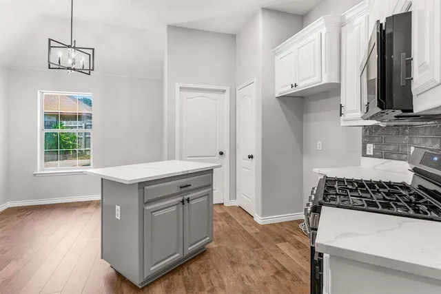 a kitchen with a stove and a window