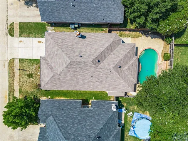 an aerial view of a house with a swimming pool