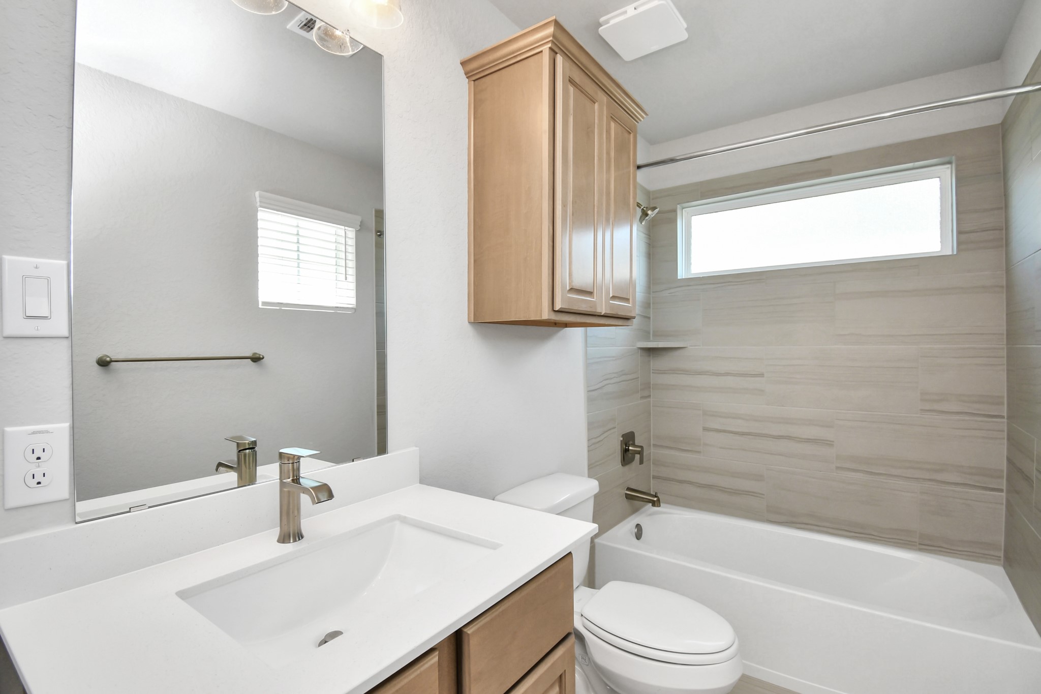 3106 Native Spg Drive Spring, TX 77373 - Photo 36 of 38 Secondary bath features tile flooring, bath/shower combo with tile surround, light stained wood cabinets, beautiful light countertop. Sample photo of completed home with similar floor plan. Actual colors and selections may vary.