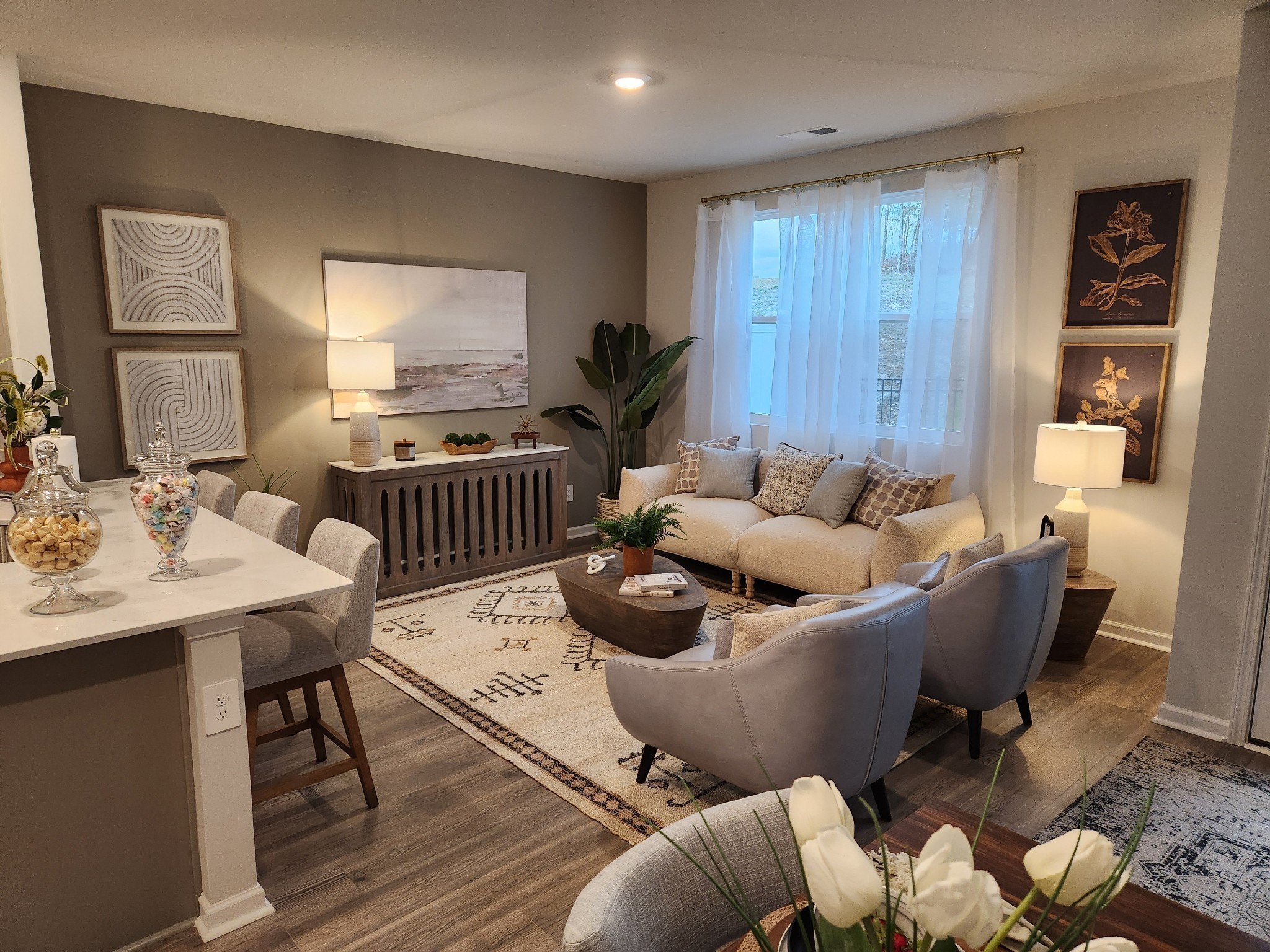a living room with furniture and wooden floor