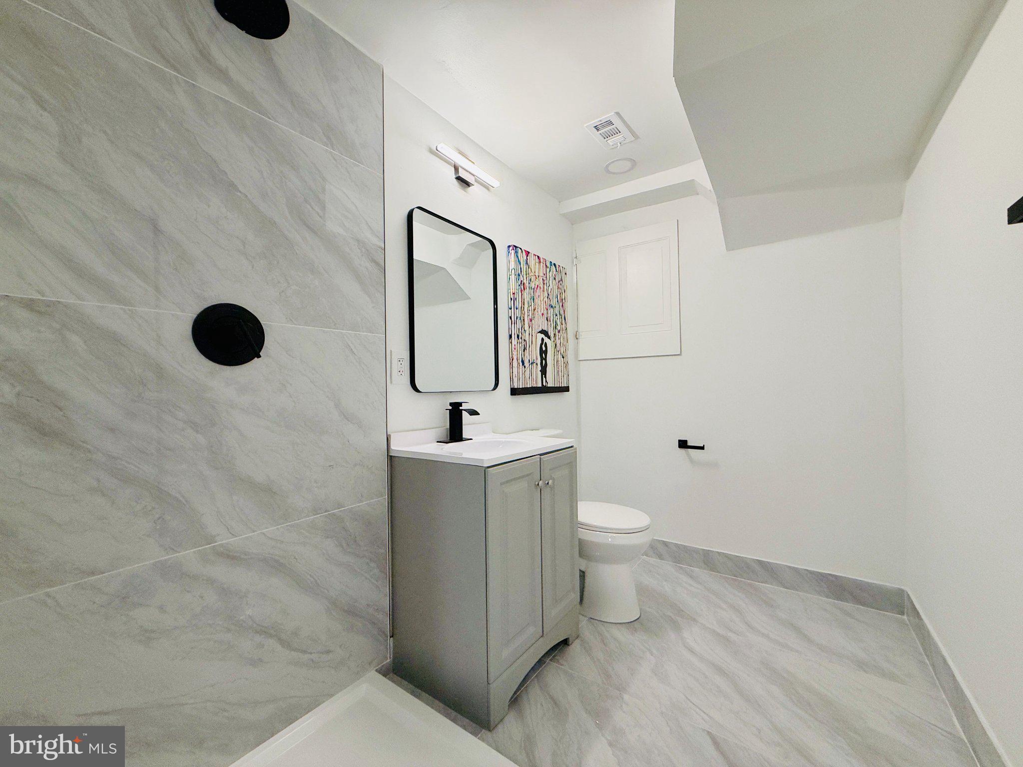 815 Whitehall Street Silver Spring, MD 20901 - Photo 31 of 39 Sleek modern bathroom with elegant tiles.