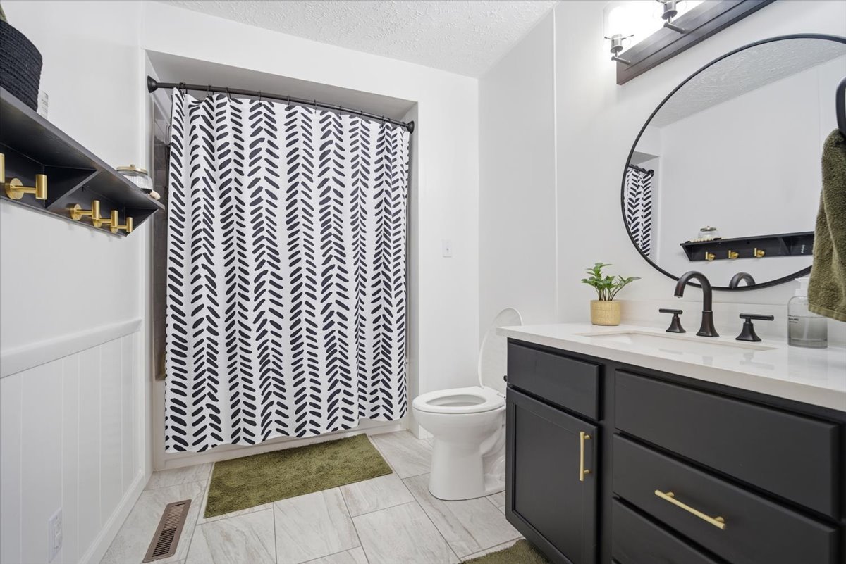 206 North Grove Street Normal, IL 61761 - Photo 14 of 24 a bathroom with a sink mirror vanity and toilet