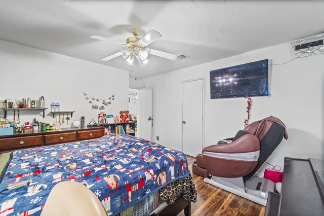 a bedroom with furniture and a chandelier