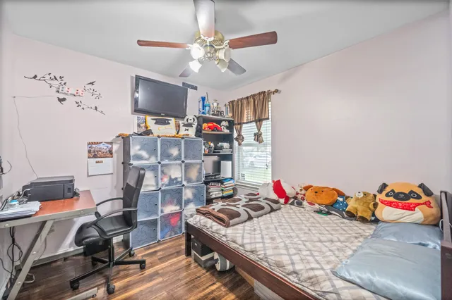 a bedroom with a bed and a chandelier