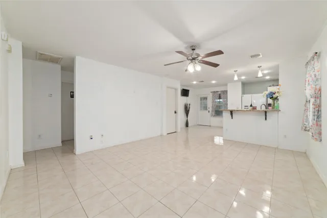 a view of an empty room with a kitchen