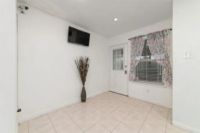 a view of a room with a fireplace and a window