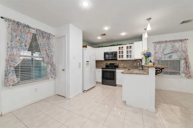 a kitchen with a refrigerator and a counter top space