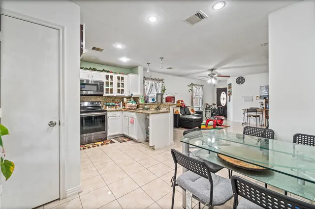 a kitchen with stainless steel appliances kitchen island granite countertop a sink and cabinets