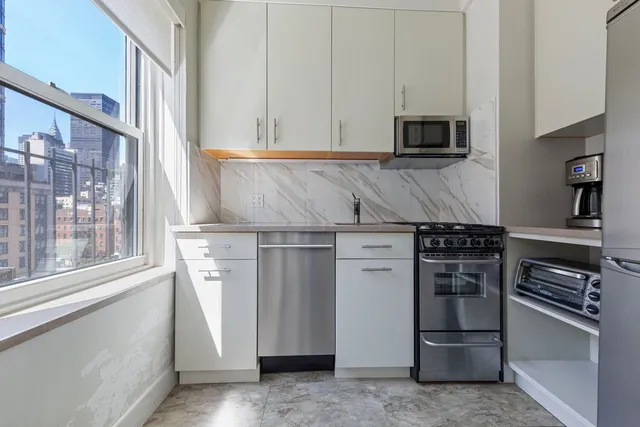 a bedroom with a bed a flat screen tv and a window