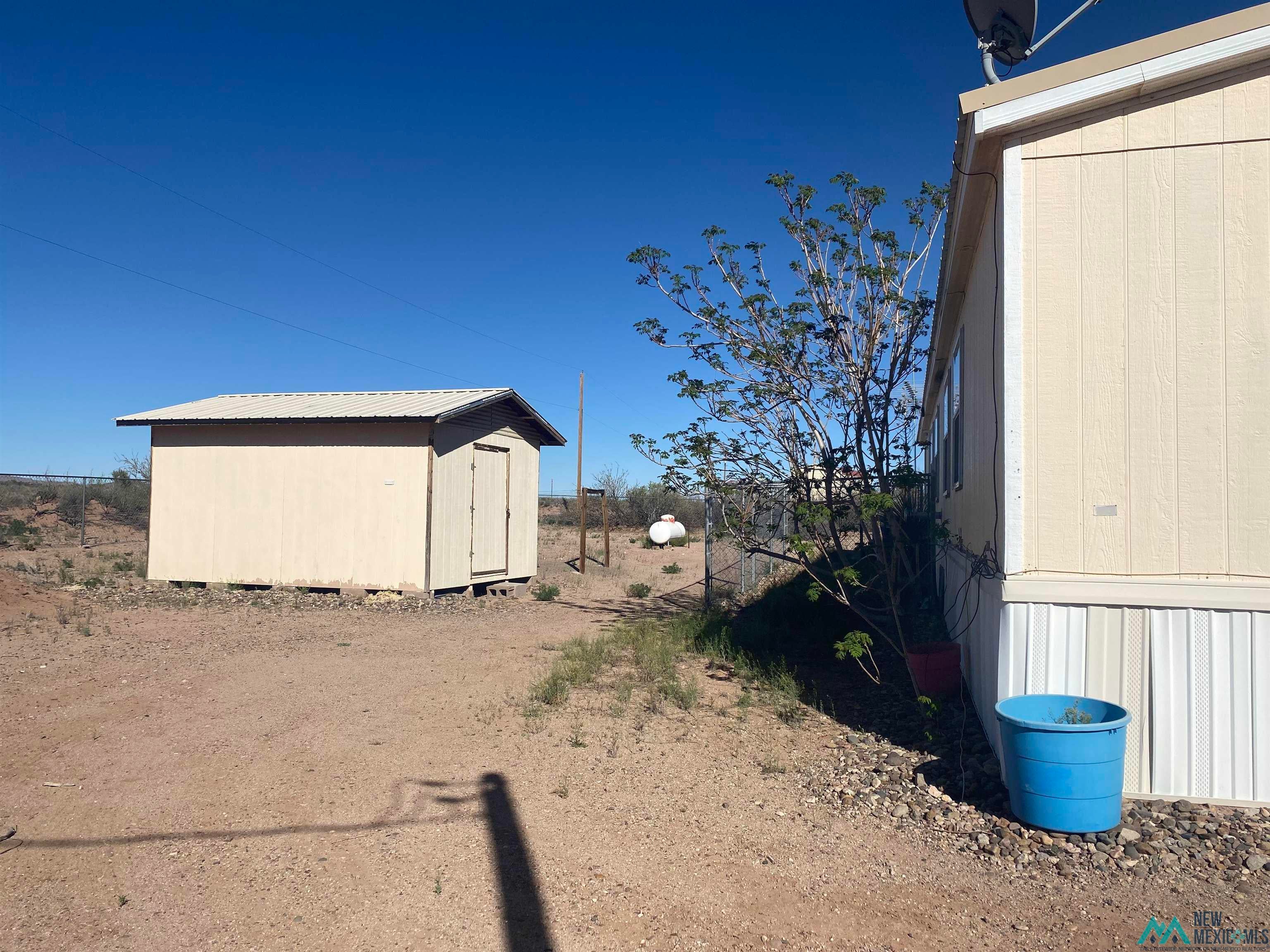 465 Irritabe Road Northeast Deming, NM 88030 - Photo 5 of 24 View of property exterior with a storage shed