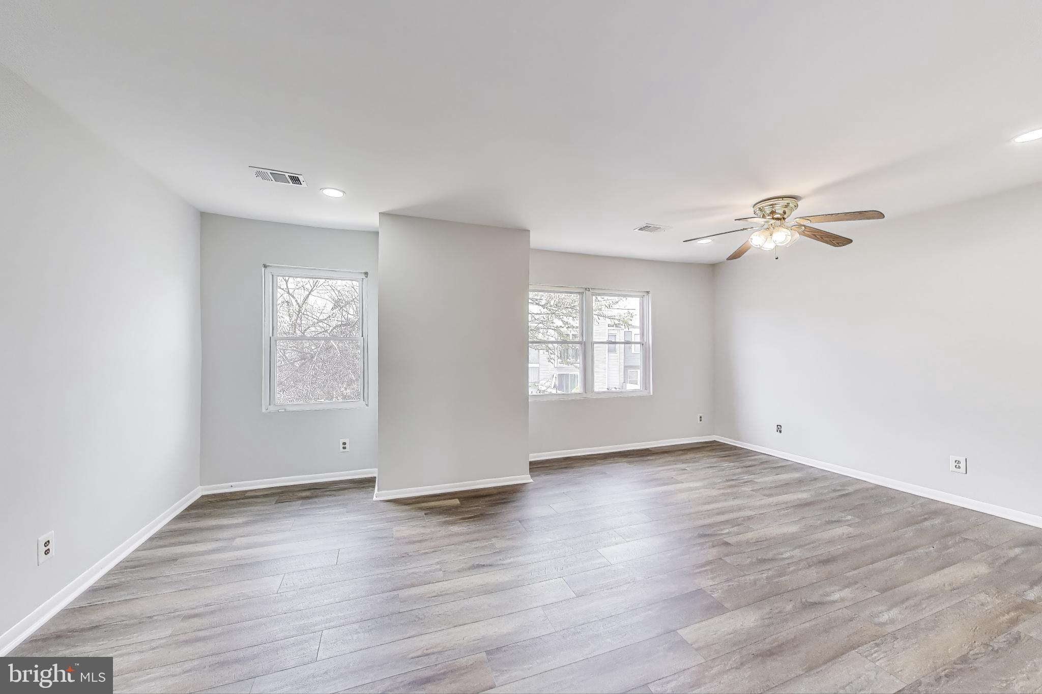 17520 Hoskinson Road Poolesville, MD 20837 - Photo 13 of 31 wooden floor in an empty room with a window