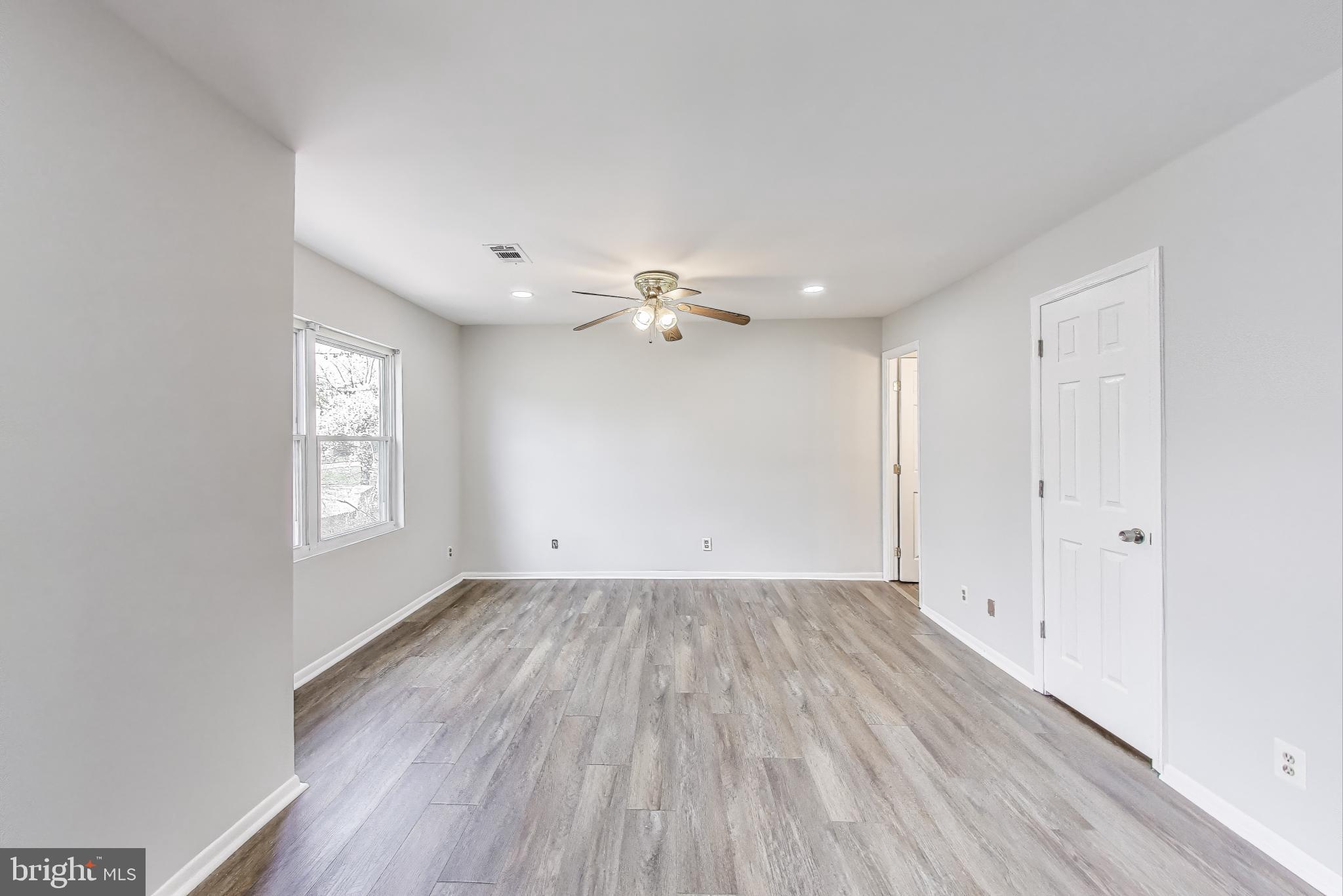 17520 Hoskinson Road Poolesville, MD 20837 - Photo 14 of 31 wooden floor in an empty room with a window