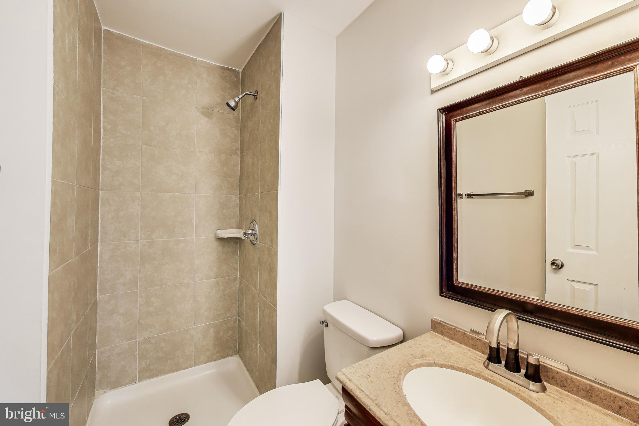 17520 Hoskinson Road Poolesville, MD 20837 - Photo 16 of 31 a bathroom with a granite countertop sink toilet and shower