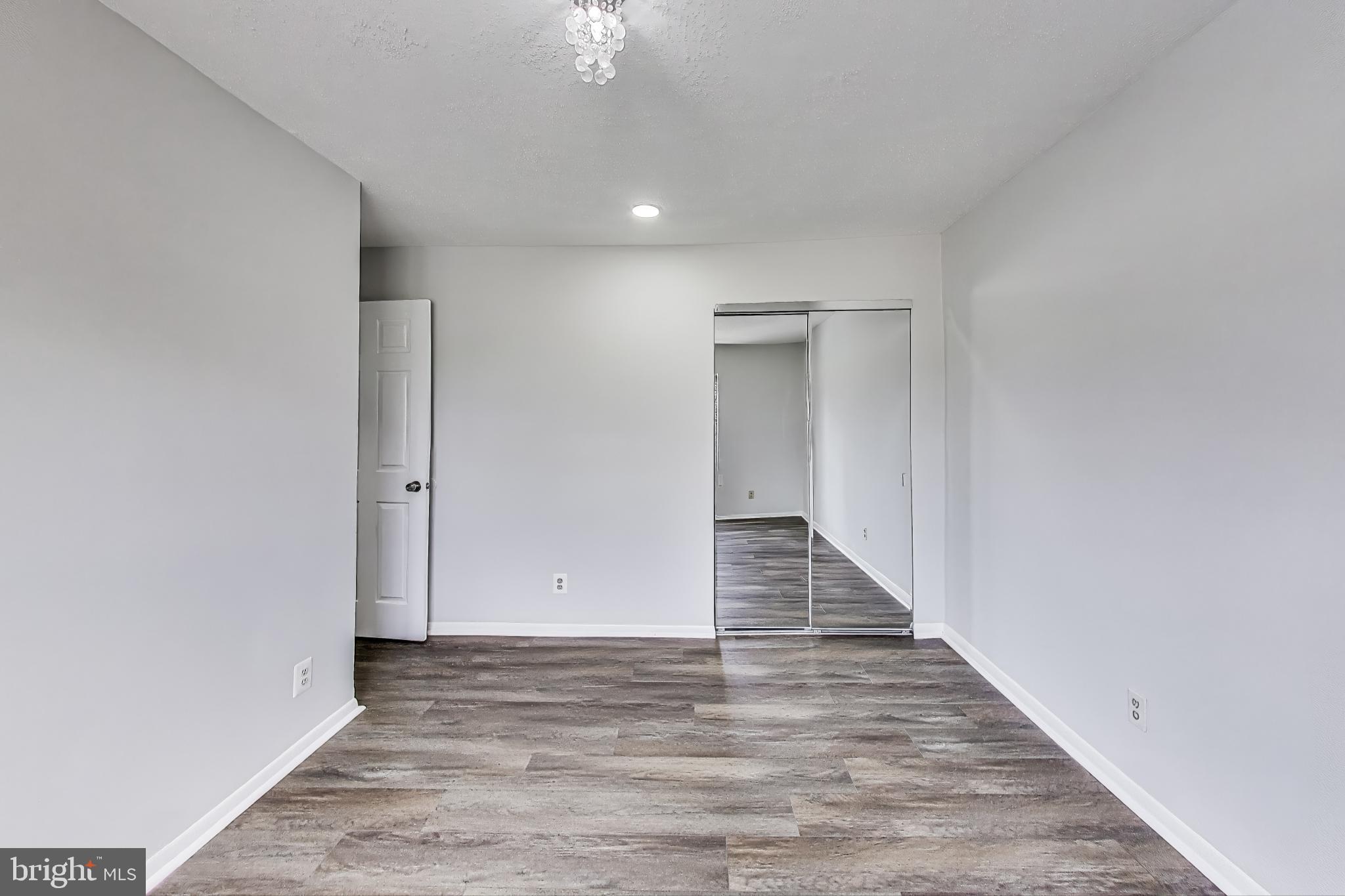 17520 Hoskinson Road Poolesville, MD 20837 - Photo 19 of 31 a view of a hallway with wooden floor