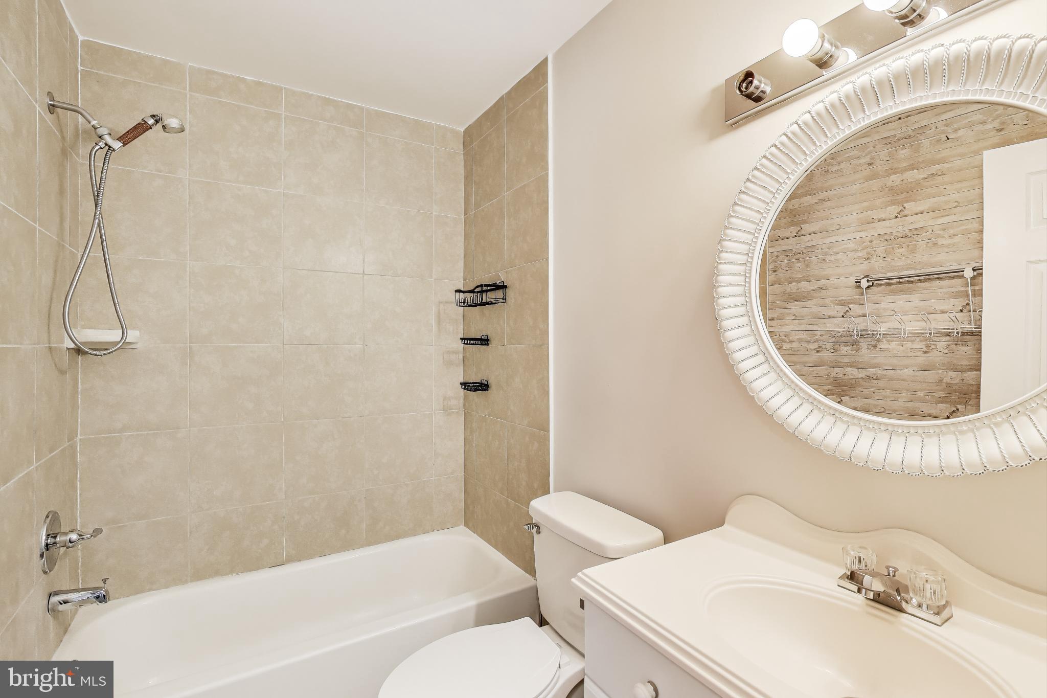 17520 Hoskinson Road Poolesville, MD 20837 - Photo 20 of 31 a bathroom with a sink a toilet and a mirror