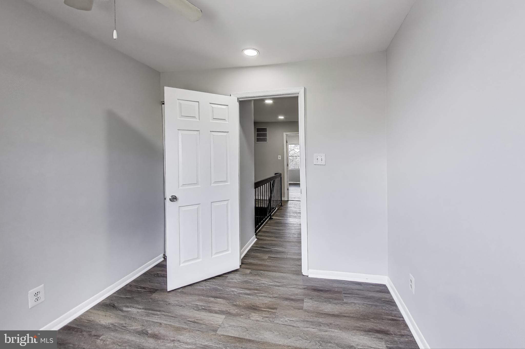 17520 Hoskinson Road Poolesville, MD 20837 - Photo 22 of 31 a view of a hallway with wooden floor and staircase
