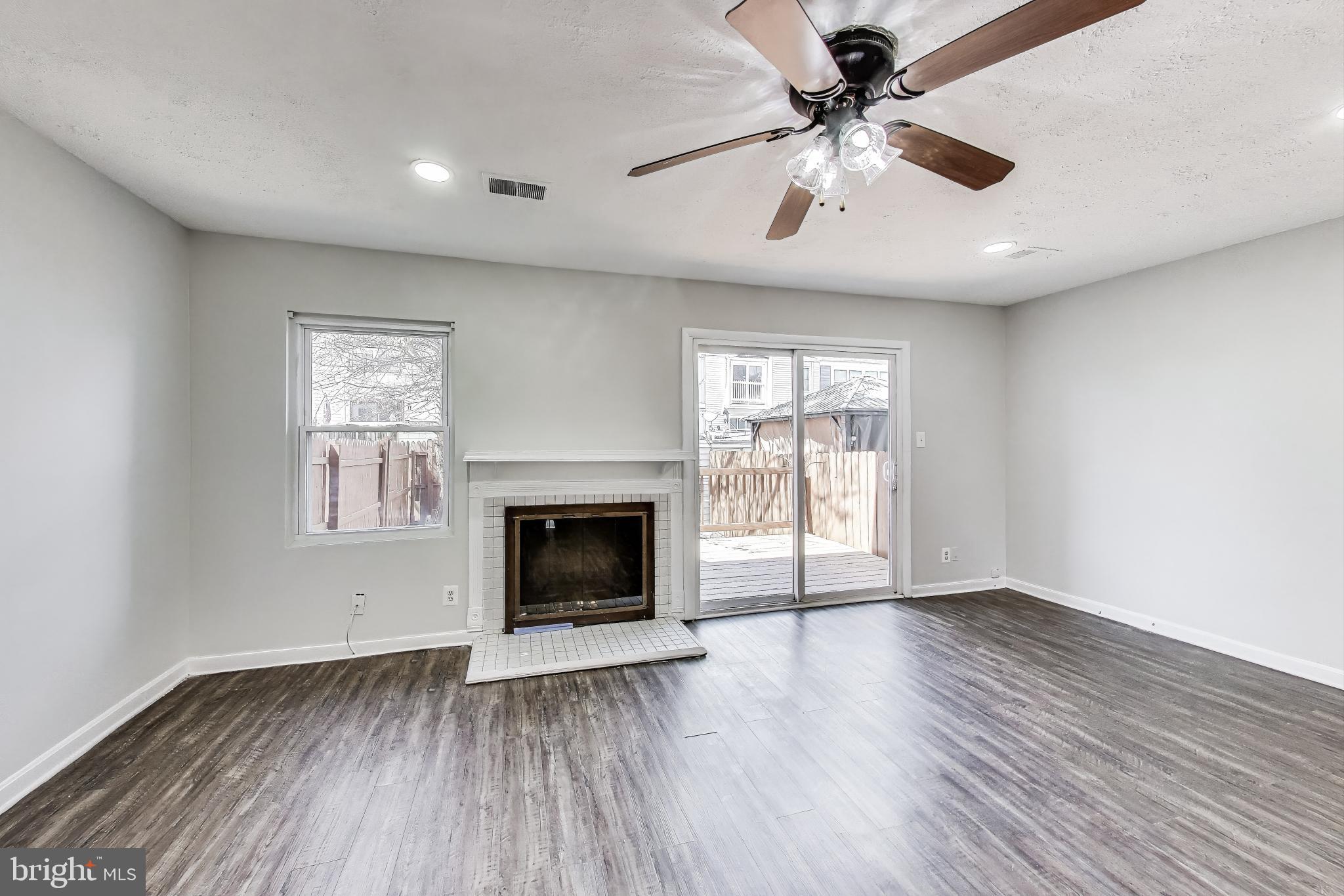 17520 Hoskinson Road Poolesville, MD 20837 - Photo 8 of 31 a view of main area fire place window and wooden floor