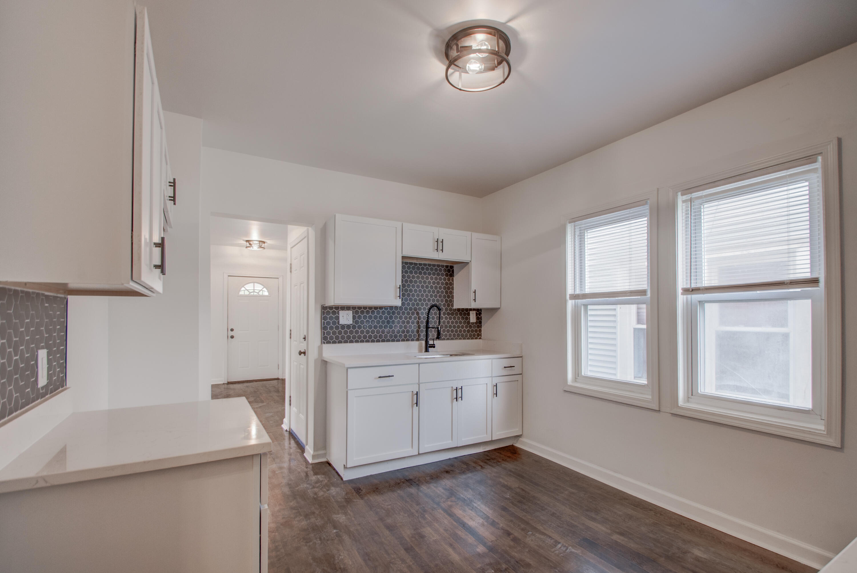 613 Tennessee Street Gary, IN 46402 - Photo 23 of 39 a kitchen with a sink stove and cabinets