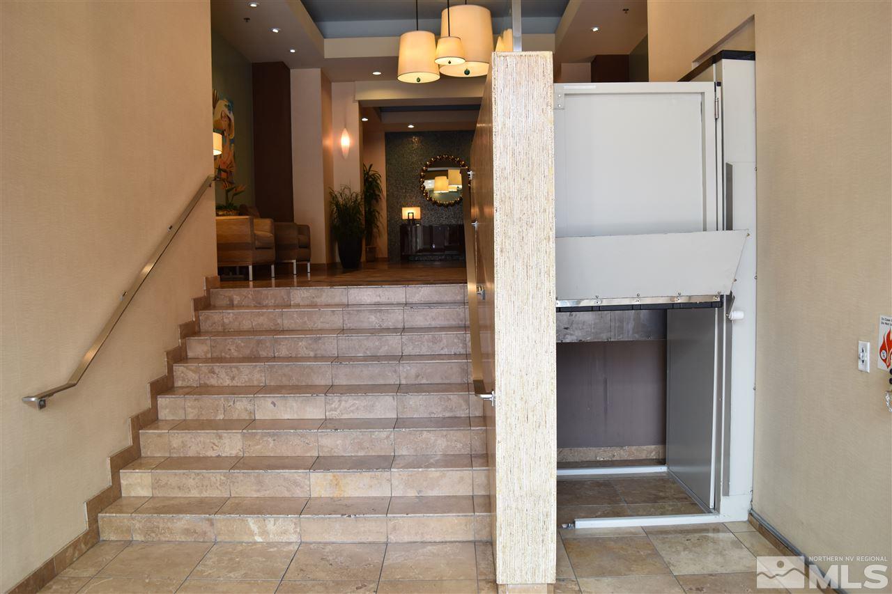50 North Sierra Street, Unit 706 Reno, NV 89501 - Photo 12 of 24 a view of staircase with white walls and wooden door