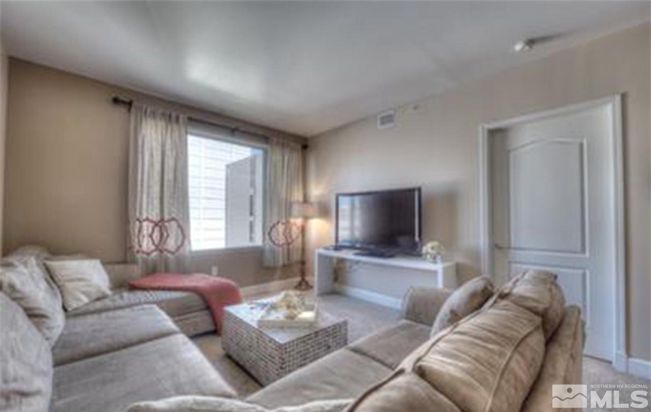 50 North Sierra Street, Unit 706 Reno, NV 89501 - Photo 4 of 24 a living room with furniture and a flat screen tv