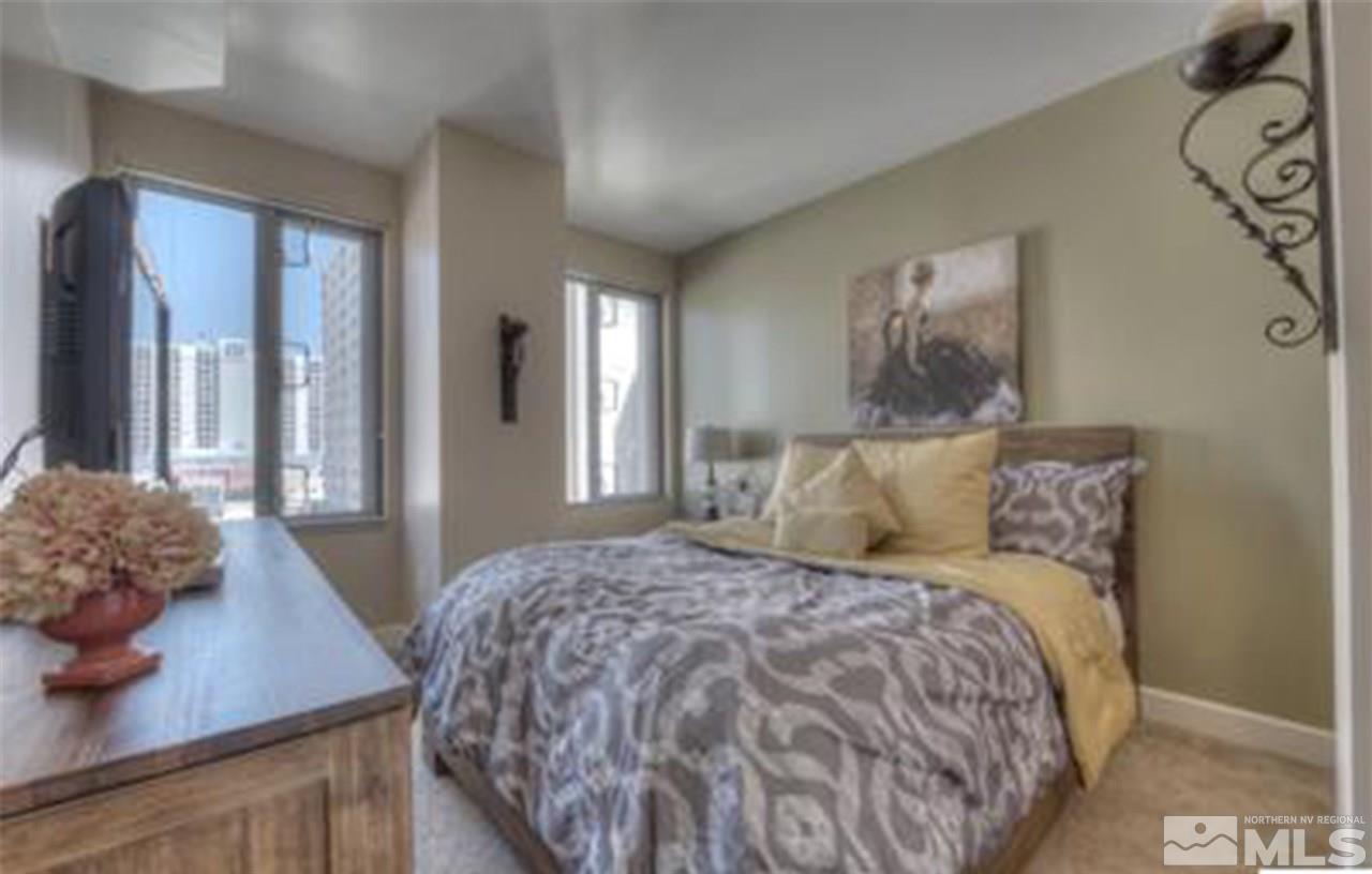 50 North Sierra Street, Unit 706 Reno, NV 89501 - Photo 5 of 24 a bedroom with a bed and a table in it