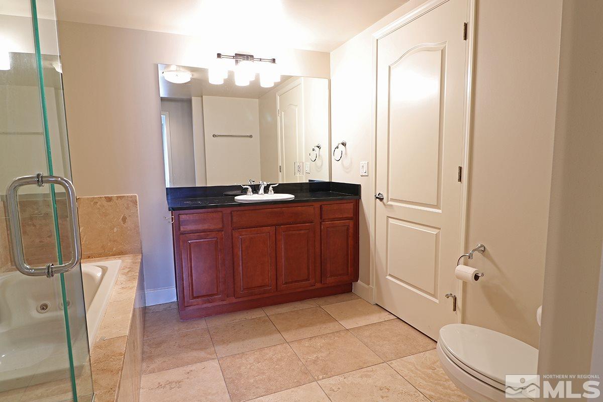 50 North Sierra Street, Unit 706 Reno, NV 89501 - Photo 6 of 24 a bathroom with a sink a toilet and shower