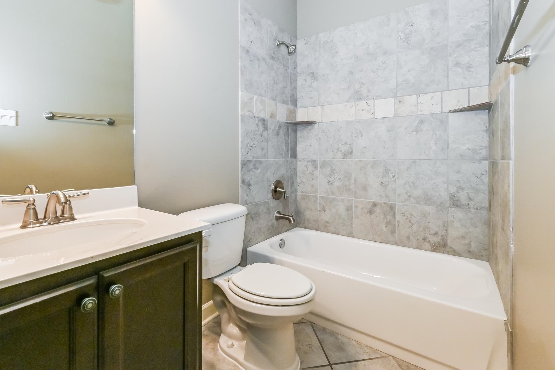 7530 Bevy Ridge Lane Memphis, TN 38125 - Photo 19 of 22 Full bathroom with tile floors, tiled shower / bath, vanity with extensive cabinet space, and toilet