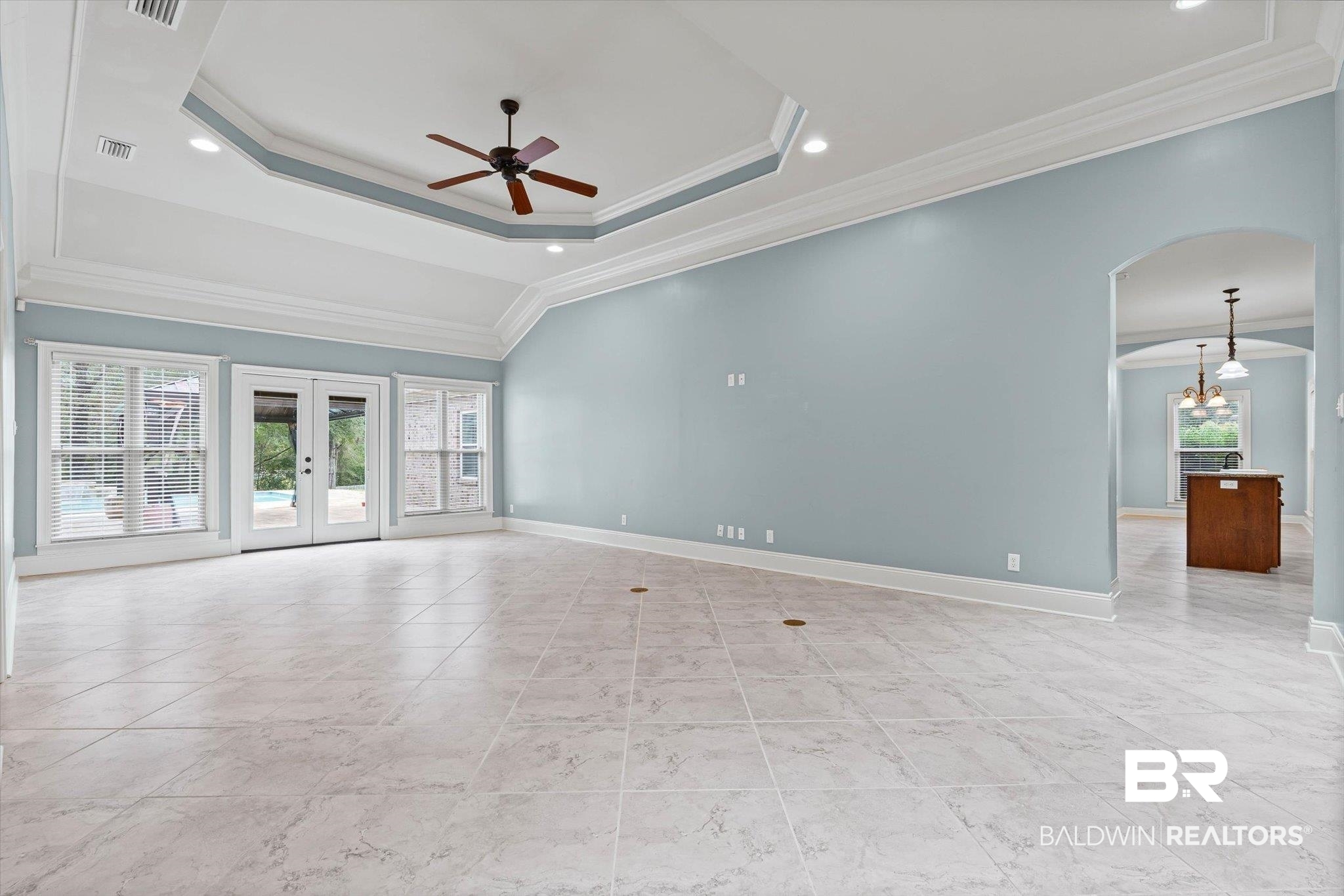 5270 Rodgers Road Eight Mile, AL 36613 - Photo 9 of 38 Unfurnished room featuring french doors, ornamental molding, arched walkways, ceiling fan, and a raised ceiling