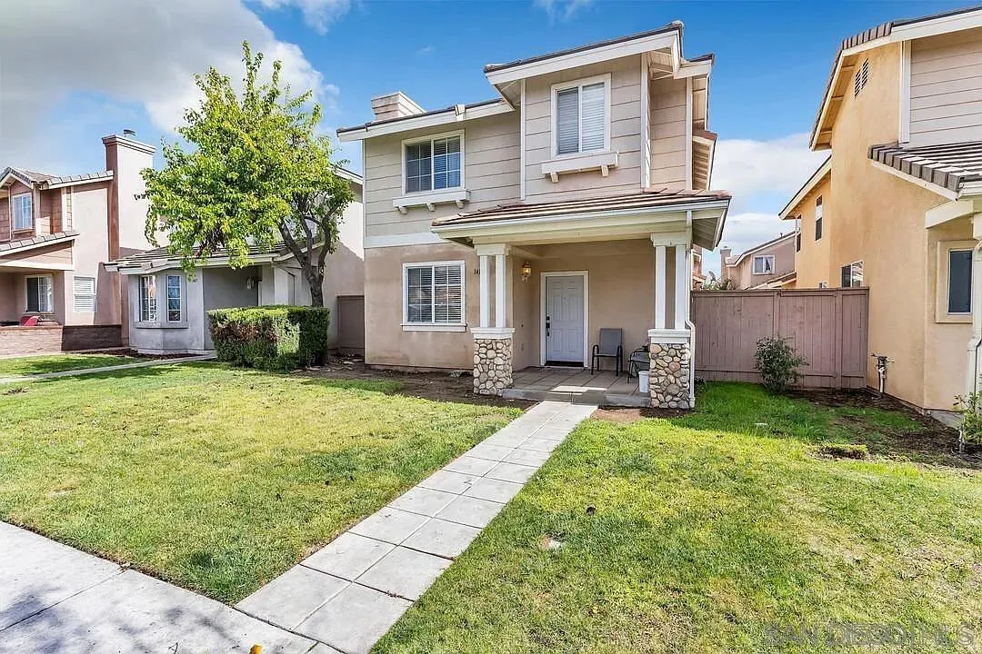 a view of a house with a yard and plants