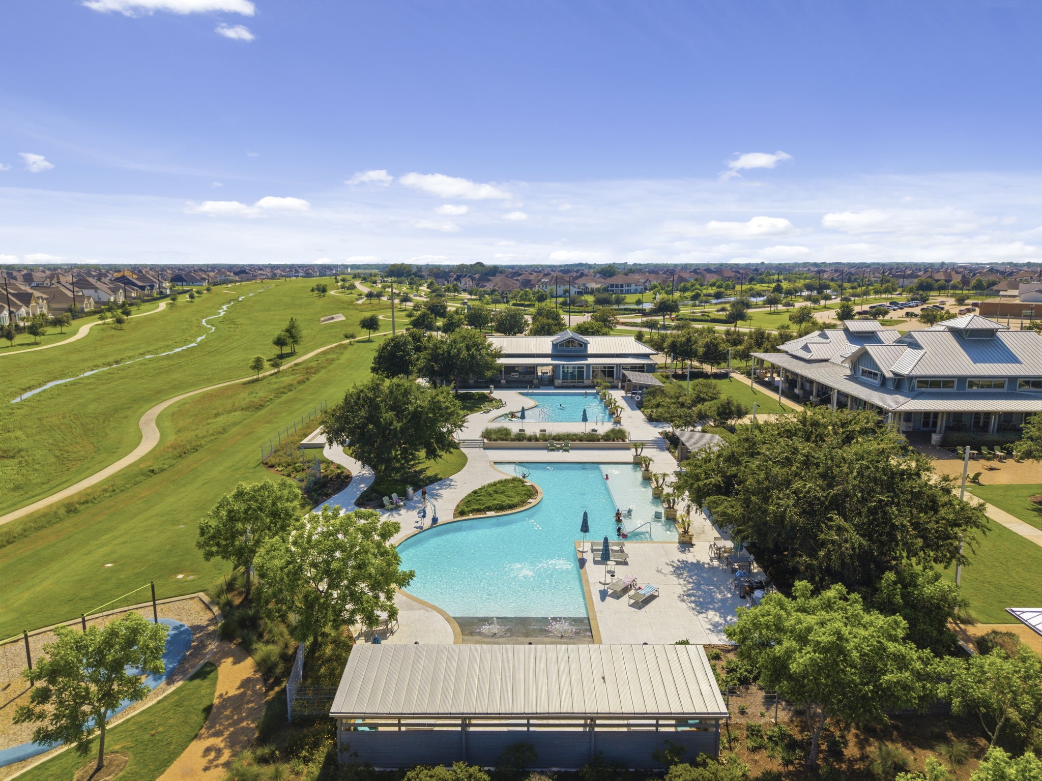 2119 Blackhawk Ridge Lane Manvel, TX 77578 - Photo 3 of 49 Welcome to resort living! Pomona's award-winning community features a stunning lagoon-style pool complex with multiple pool areas, splash features, lounge seating, a clubhouse, and scenic walking trails winding through lush green open spaces — all just minutes from your front door.