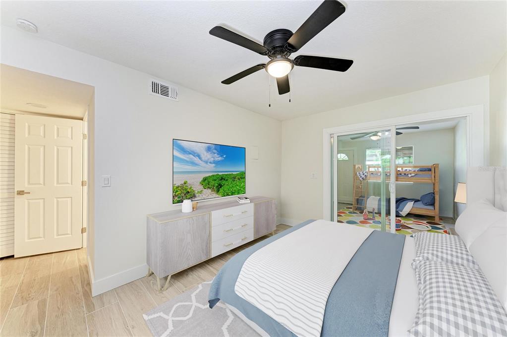 101 73rd Street, Unit 2 Holmes Beach, FL 34217 - Photo 13 of 55 a bedroom with a bed and a large window