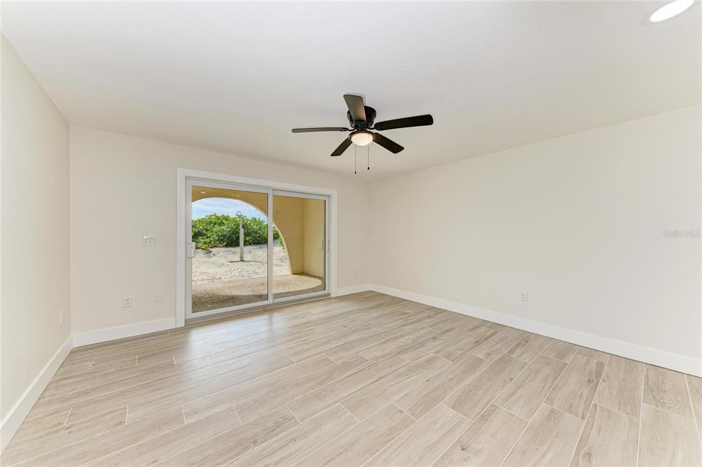 101 73rd Street, Unit 2 Holmes Beach, FL 34217 - Photo 18 of 55 a view of empty room with wooden floor and fan