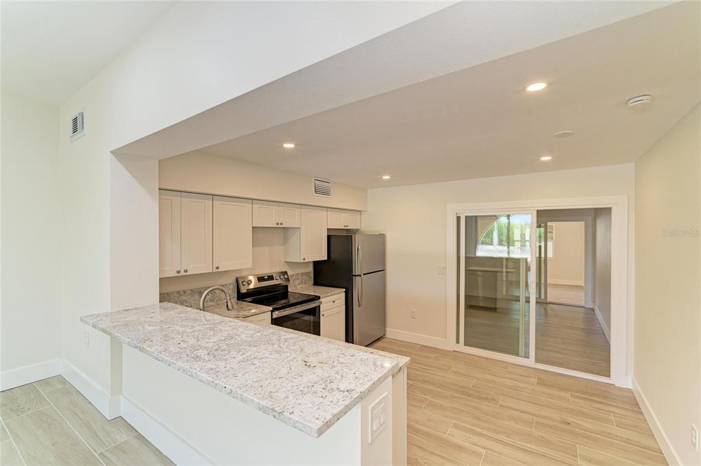 101 73rd Street, Unit 2 Holmes Beach, FL 34217 - Photo 25 of 54 a kitchen with kitchen island a sink stainless steel appliances and counter space
