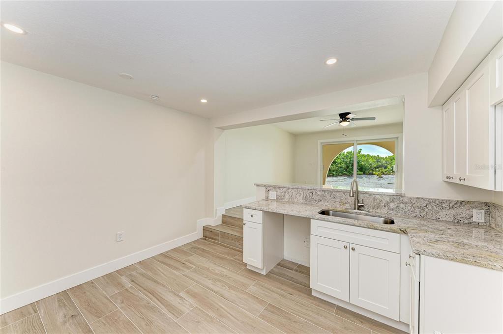 101 73rd Street, Unit 2 Holmes Beach, FL 34217 - Photo 26 of 55 a kitchen with a sink cabinets stainless steel appliances and a window