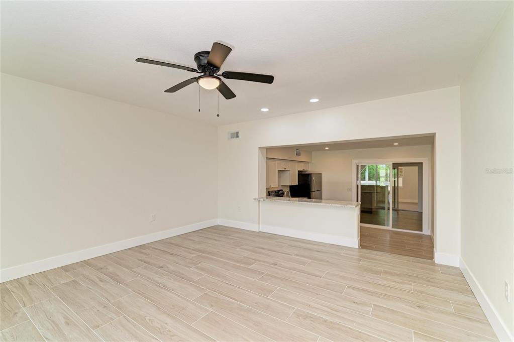 101 73rd Street, Unit 2 Holmes Beach, FL 34217 - Photo 26 of 54 a view of empty room with wooden floor and ceiling fan