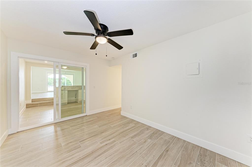 101 73rd Street, Unit 2 Holmes Beach, FL 34217 - Photo 28 of 54 a view of empty room with wooden floor and fan